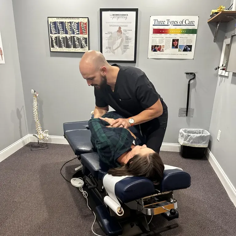 Chiropractor Dr. Jared Heath Performing Chiropractic Adjustment on Patient at Carolina Family Chiropractic in Fayetteville, North Carolina.